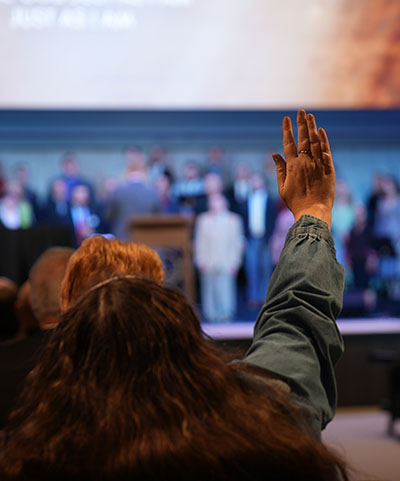 Woman Raising hand in Worship