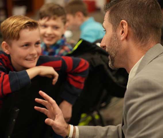 Pastor talking to kids in kids church