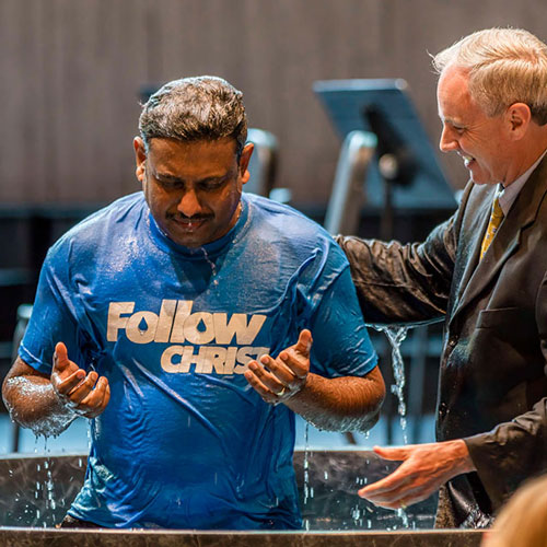 Man Baptized with hands raised